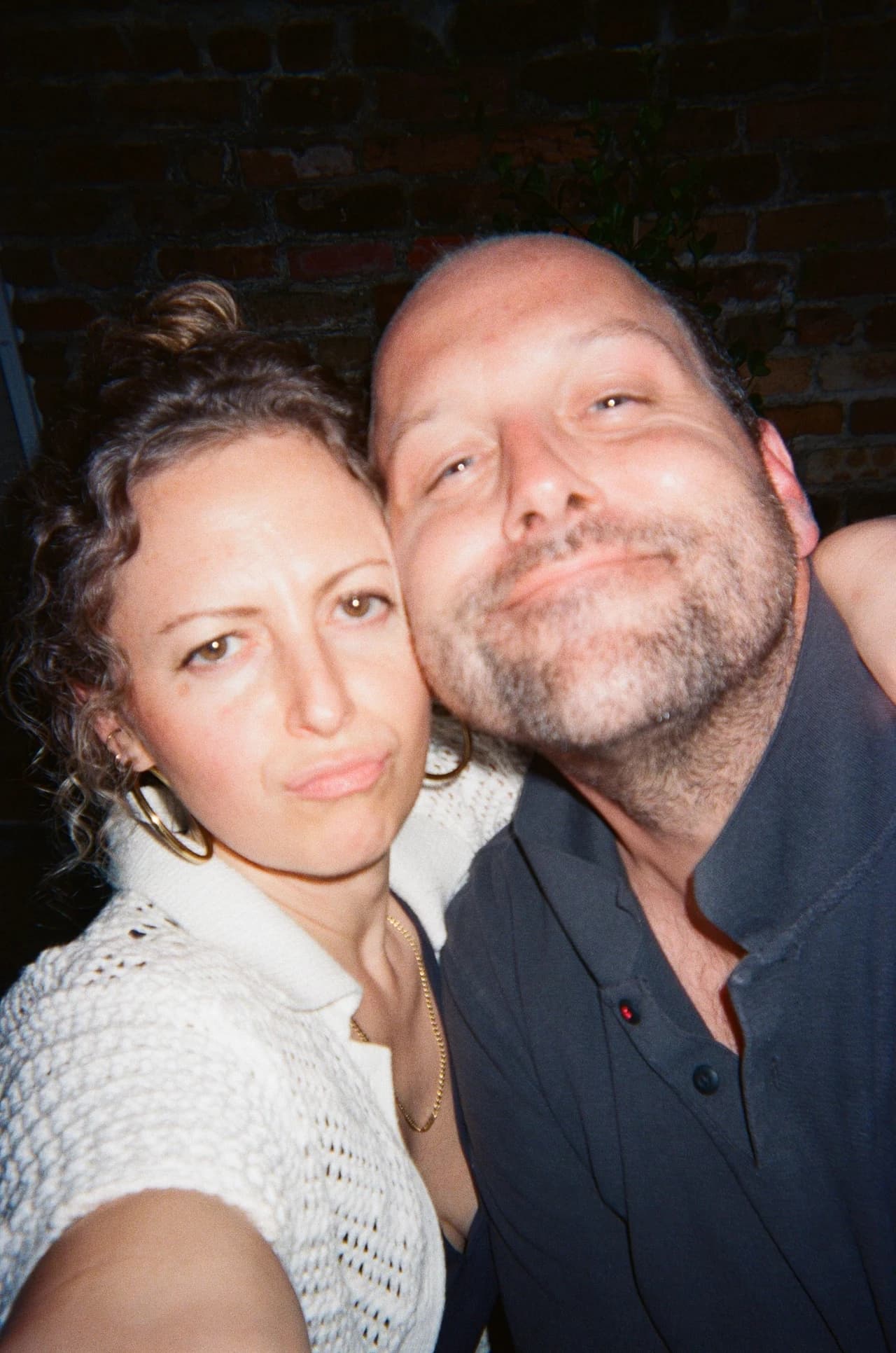 A photograph of two people together, with a decorative jigsaw-piece outline overlay.